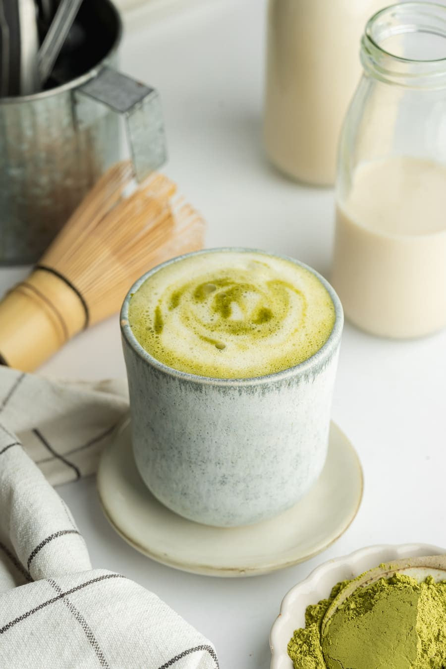 Whisked organic matcha latte in a cup – natural energy boost and focus-enhancing superfood.