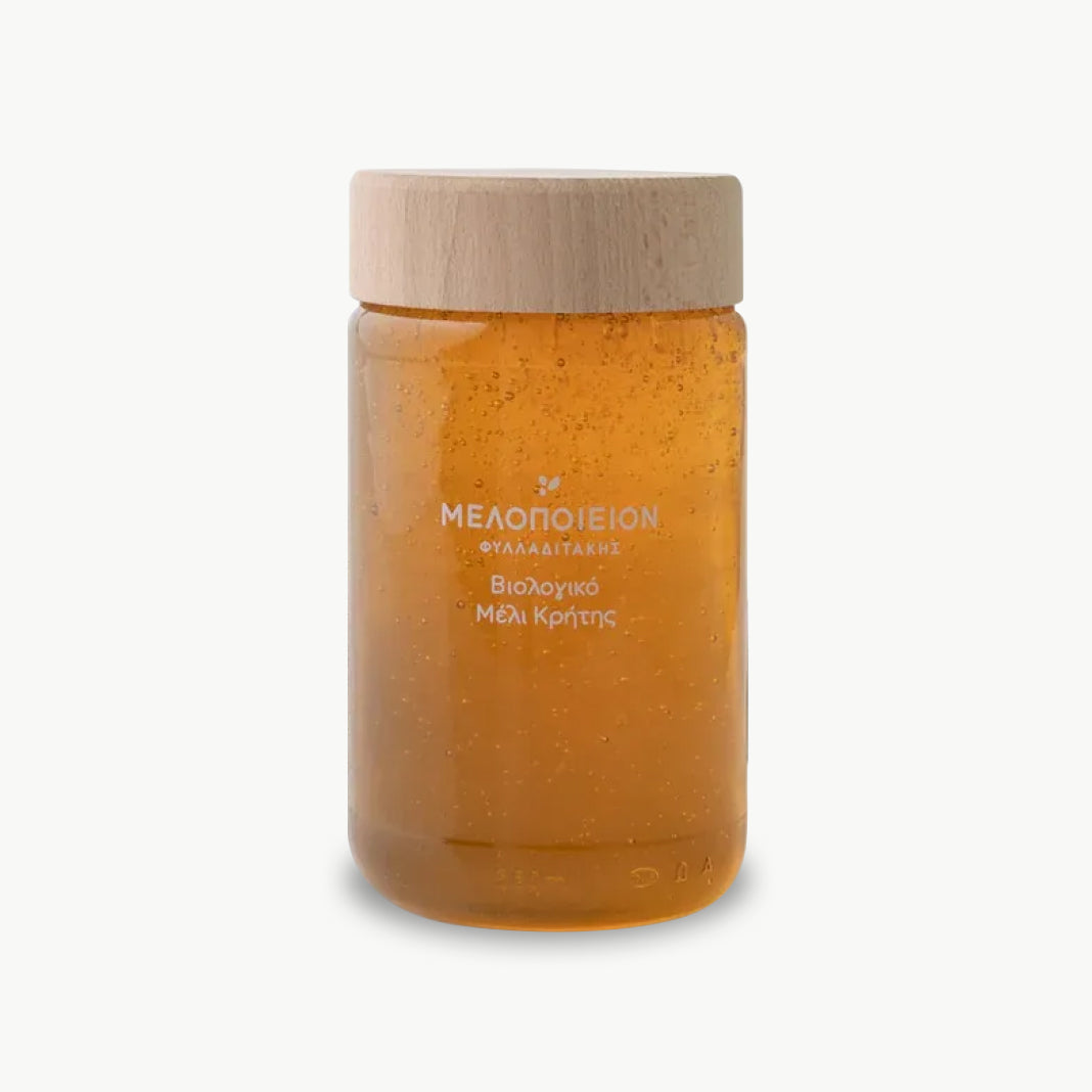 Organic premium thyme honey from Crete in glass jar with wooden lid