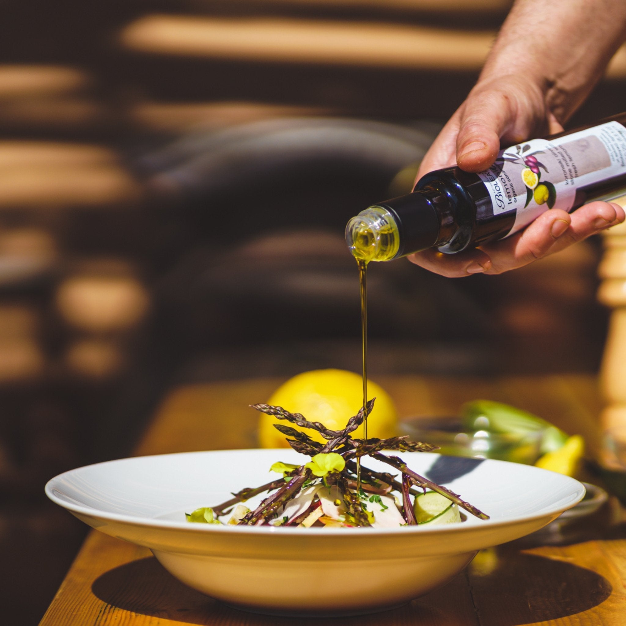 BIOLEA organic olive oil with Lemons over asparagus and cheese.