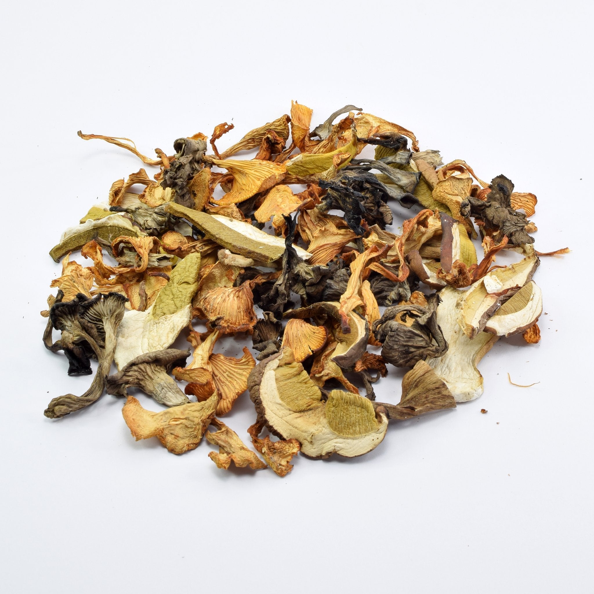 Organic Wild Mushrooms | Mix of organic forest mushrooms on the table - porcini, black trumpet and chanterelles.