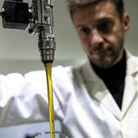 Process of bottling premium EVOO into elegant black Murano glass bottles. 